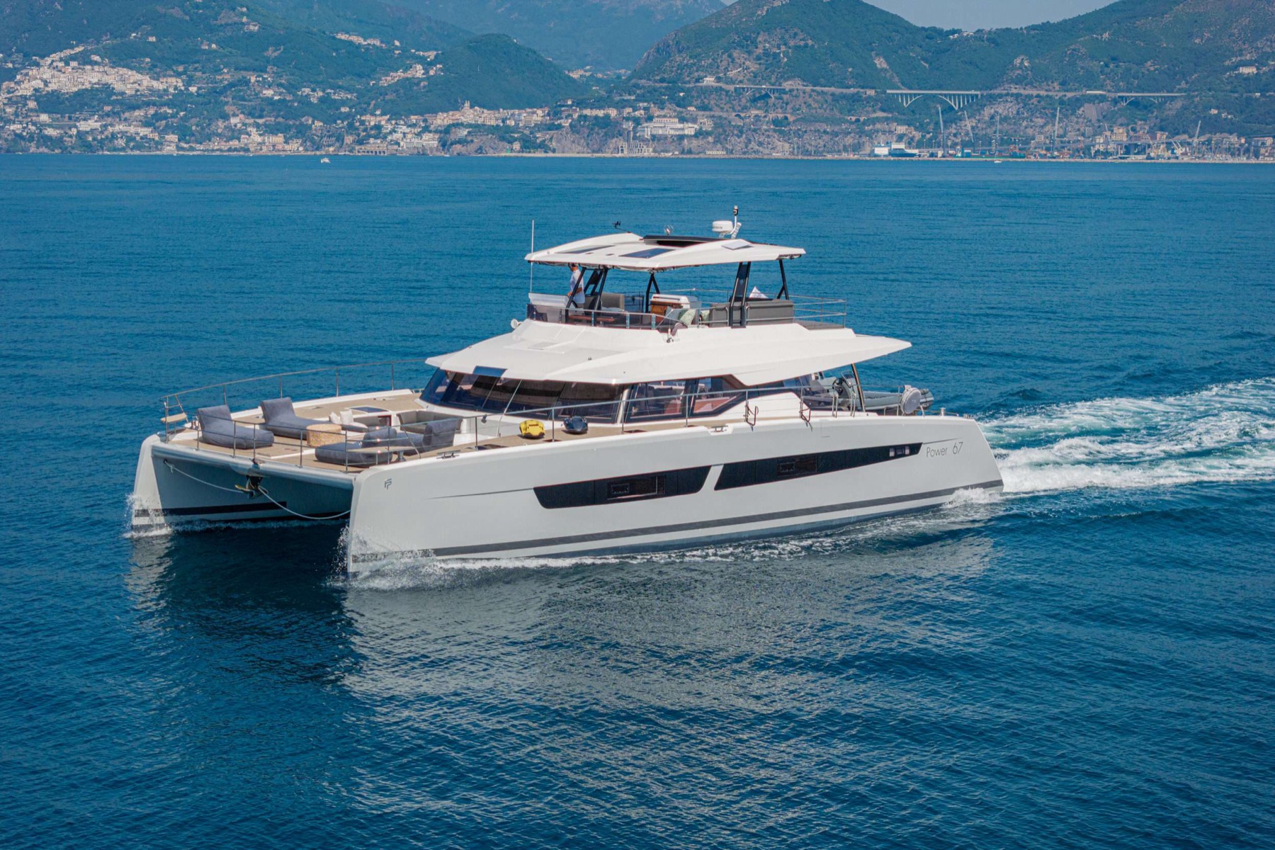 CORE, a Fountaine Pajot power catamaran, cruising along the coast